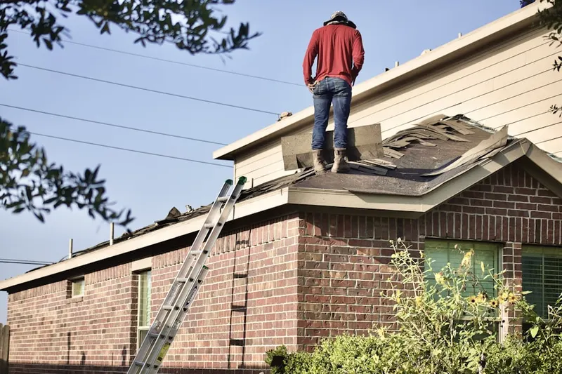 Professional roofer working on a residential roof in Fox Hollow